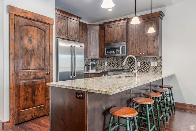 14160 N Council Fire Trl, Heber City, UT 84032 - kitchen with stainless steel appliances, baseboards, a peninsula, a sink, and dark wood-style flooring