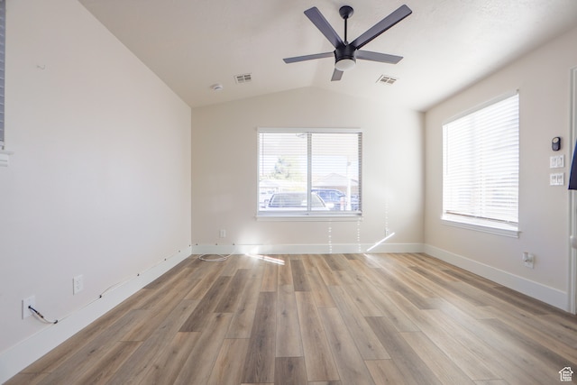 spare room with ceiling fan, lofted ceiling, and light hardwood / wood-style floors