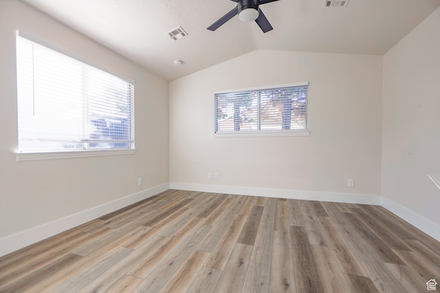 unfurnished room featuring vaulted ceiling, ceiling fan, and light hardwood / wood-style flooring
