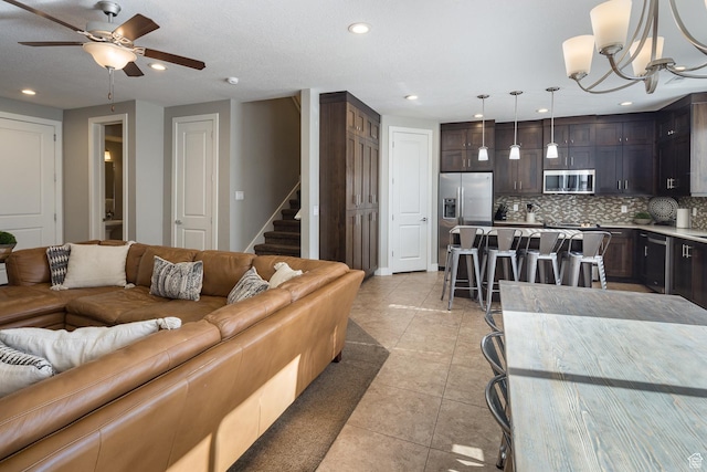 635 W 0470 N, Moab, UT 84532 - tiled living room with ceiling fan with notable chandelier