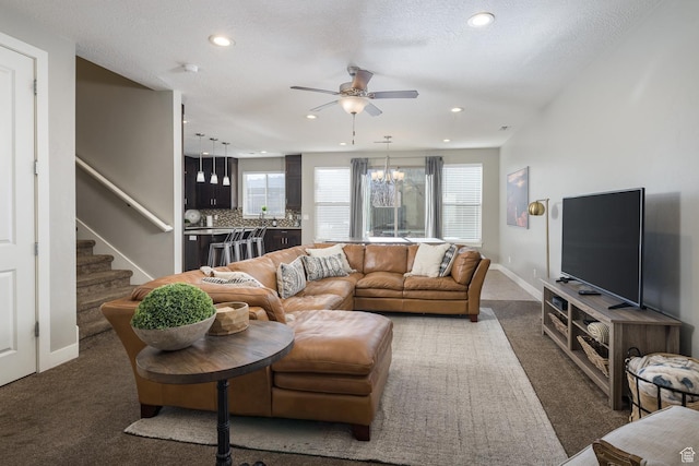 635 W 0470 N, Moab, UT 84532 - living room with a textured ceiling, dark colored carpet, and ceiling fan with notable chandelier