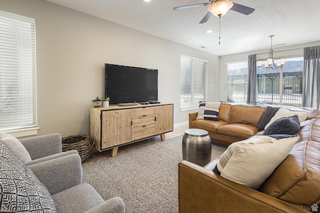 631 W 470 N, Moab, UT 84532 - carpeted living room featuring ceiling fan with notable chandelier and a textured ceiling
