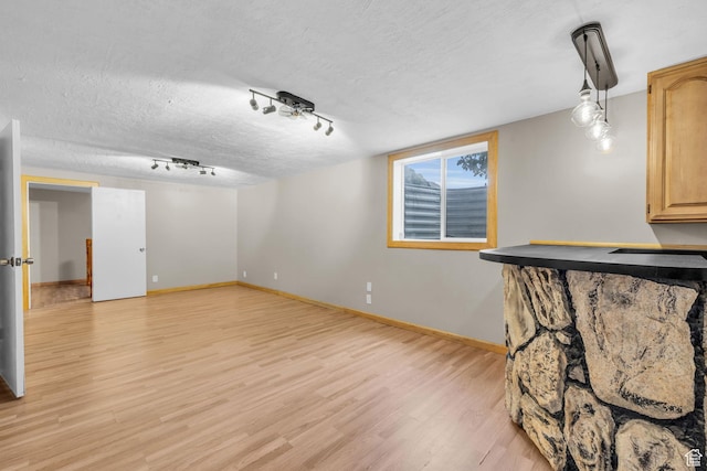 751 W 4350 S, Riverdale, UT 84405 - interior space with rail lighting, light wood-style flooring, baseboards, and a textured ceiling