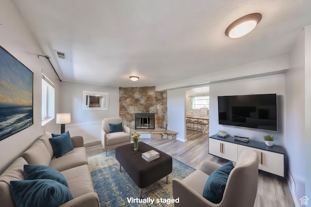 1591 N Marilyn Dr, Syracuse, UT 84075 - living room featuring visible vents, a large fireplace, and wood finished floors