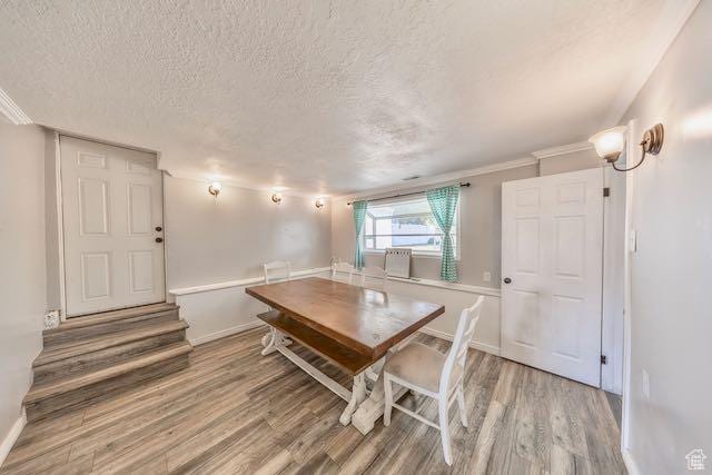 1591 N Marilyn Dr, Syracuse, UT 84075 - dining area featuring a textured ceiling, baseboards, and light wood-style floors