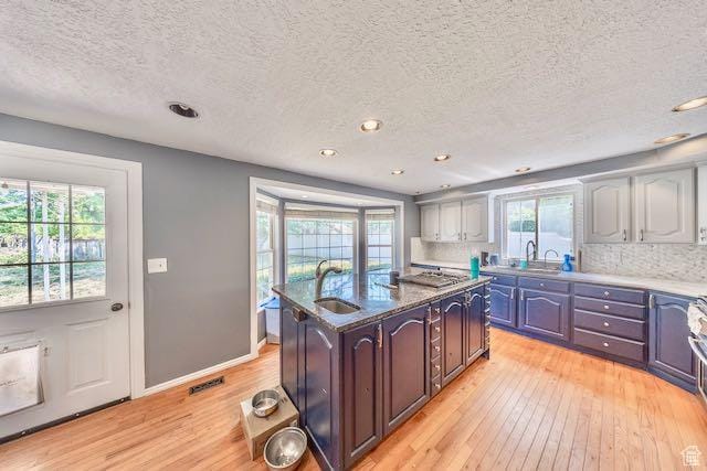 1591 N Marilyn Dr, Syracuse, UT 84075 - kitchen with a sink, a center island with sink, light wood-type flooring, and a textured ceiling