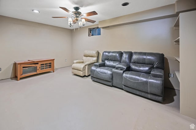 home theater with concrete flooring and ceiling fan