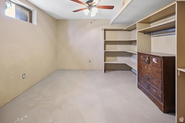 below grade area with ceiling fan