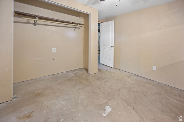unfurnished bedroom featuring a closet, ceiling fan, and unfinished concrete floors