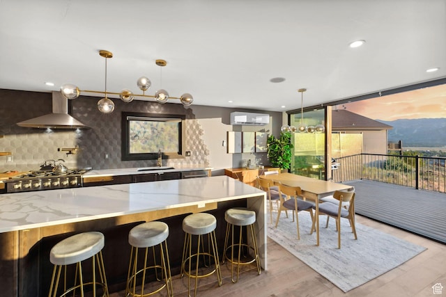6387 Silver Sage Dr, Park City, UT 84098 - kitchen featuring decorative light fixtures, tasteful backsplash, sink, light stone counters, and wall chimney exhaust hood