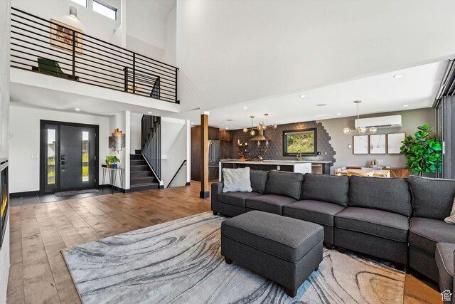 6387 Silver Sage Dr, Park City, UT 84098 - living room featuring wood-type flooring, an AC wall unit, and a high ceiling