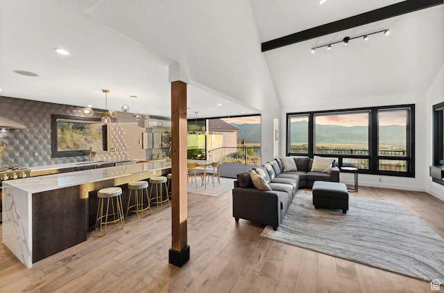 6387 Silver Sage Dr, Park City, UT 84098 - living room with sink, beam ceiling, high vaulted ceiling, and light wood-type flooring