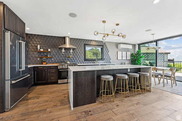 6387 Silver Sage Dr, Park City, UT 84098 - kitchen featuring plenty of natural light, a wall unit AC, wall chimney range hood, and premium appliances