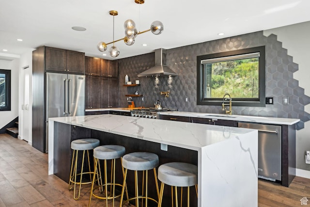 6387 Silver Sage Dr, Park City, UT 84098 - kitchen featuring stainless steel appliances, a kitchen island, sink, and wall chimney range hood