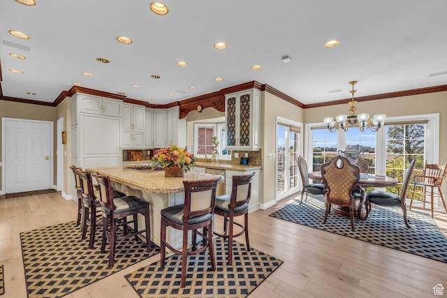 327 N 1430 E, Logan, UT 84321 - dining area featuring crown molding, a notable chandelier, and light hardwood / wood-style floors