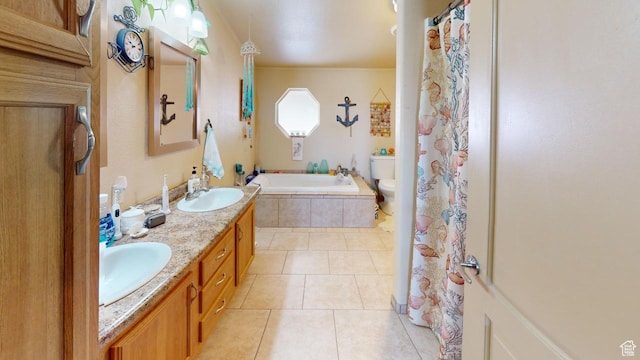 990 S Freedom Way, Big Water, UT 84741 - bathroom featuring tile patterned flooring, vanity, a relaxing tiled tub, and toilet