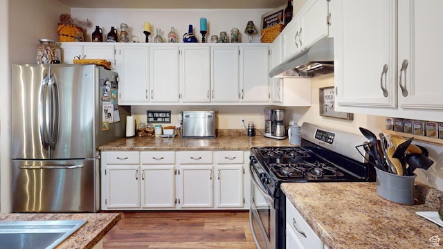 990 S Freedom Way, Big Water, UT 84741 - kitchen featuring white cabinetry, appliances with stainless steel finishes, dark wood-type flooring, and light stone counters