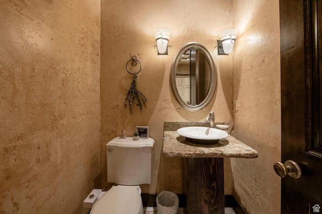 half bathroom with a sink and toilet