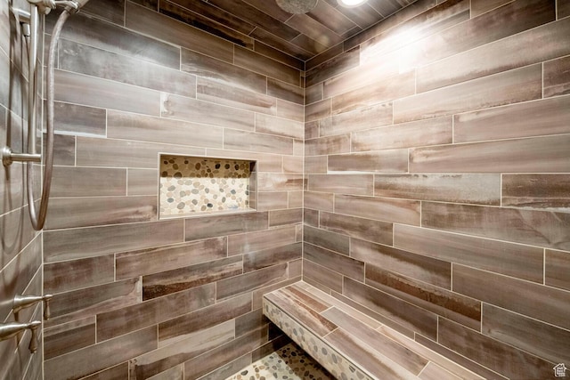 bathroom with tiled shower