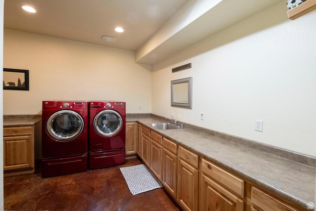 clothes washing area with cabinet space, separate washer and dryer, a sink, and recessed lighting