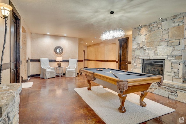 playroom with pool table, a stone fireplace, and recessed lighting