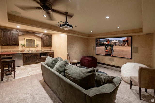 home theater room featuring light colored carpet, a raised ceiling, and recessed lighting