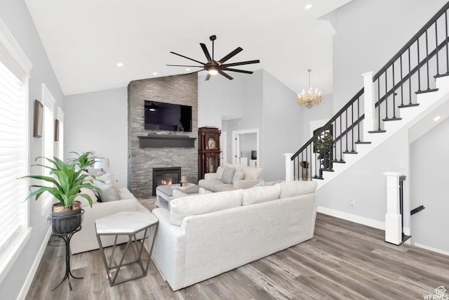 living room featuring ceiling fan, high vaulted ceiling, hardwood / wood-style floors, and a fireplace