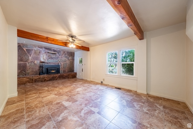 89 W 100 S, Kanab, UT 84741 - unfurnished living room featuring tile patterned floors, beam ceiling, a stone fireplace, and ceiling fan