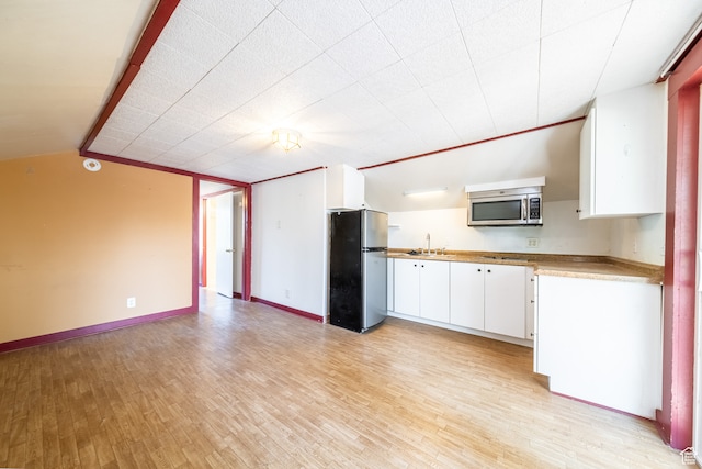 89 W 100 S, Kanab, UT 84741 - kitchen featuring sink, white cabinetry, light hardwood / wood-style flooring, and stainless steel appliances