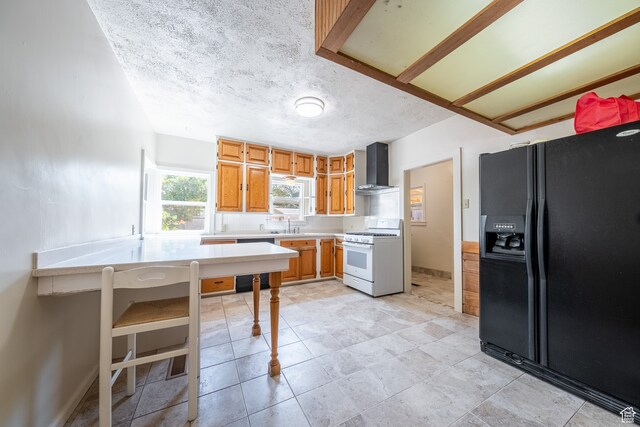89 W 100 S, Kanab, UT 84741 - kitchen with light tile patterned flooring, dishwashing machine, wall chimney range hood, black fridge with ice dispenser, and white range with gas cooktop