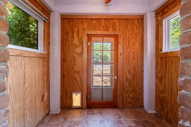 89 W 100 S, Kanab, UT 84741 - entryway with tile patterned flooring, wooden walls, and a wealth of natural light
