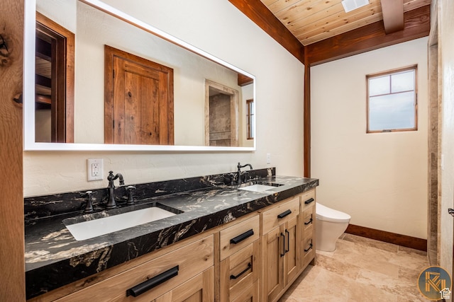 5605 N Johnson Canyon Rd, Kanab, UT 84741 - bathroom featuring wooden ceiling with exposed beams, double vanity, toilet, and baseboards