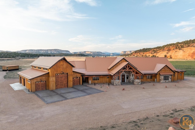 5605 N Johnson Canyon Rd, Kanab, UT 84741 - rustic home with driveway, a mountain view, and metal roof