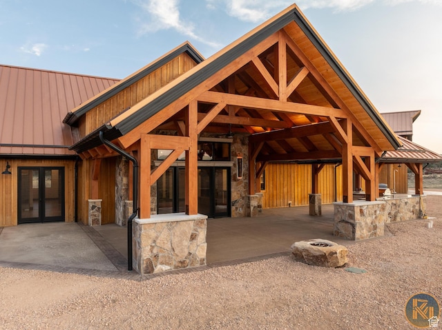 5605 N Johnson Canyon Rd, Kanab, UT 84741 - view of front of house with a standing seam roof, metal roof, french doors, and stone siding