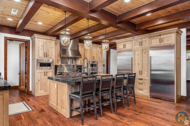 5605 N Johnson Canyon Rd, Kanab, UT 84741 - kitchen with stainless steel appliances, wooden ceiling with exposed beams, dark wood finished floors, light brown cabinetry, and a kitchen bar