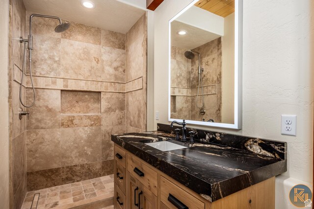 5605 N Johnson Canyon Rd, Kanab, UT 84741 - bathroom featuring a tile shower, vanity, and recessed lighting