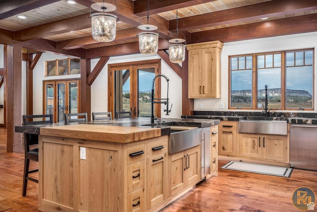 5605 N Johnson Canyon Rd, Kanab, UT 84741 - kitchen featuring light brown cabinetry, wood ceiling with exposed beams, butcher block countertops, a sink, and light wood finished floors