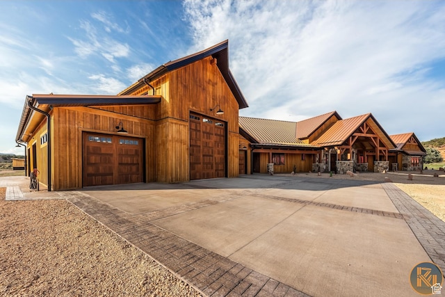 5605 N Johnson Canyon Rd, Kanab, UT 84741 - view of front of house featuring driveway, a garage, and metal roof