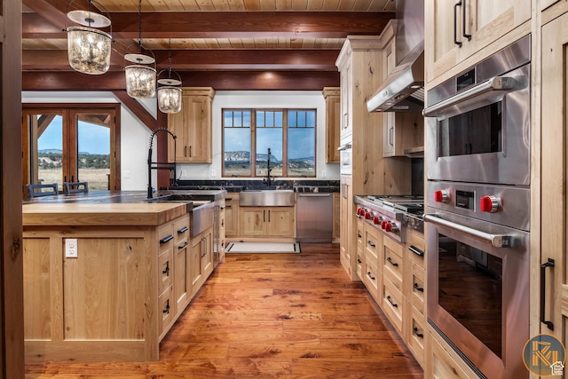 5605 N Johnson Canyon Rd, Kanab, UT 84741 - kitchen featuring butcher block countertops, light brown cabinets, light wood-style floors, wood ceiling with exposed beams, and stainless steel appliances