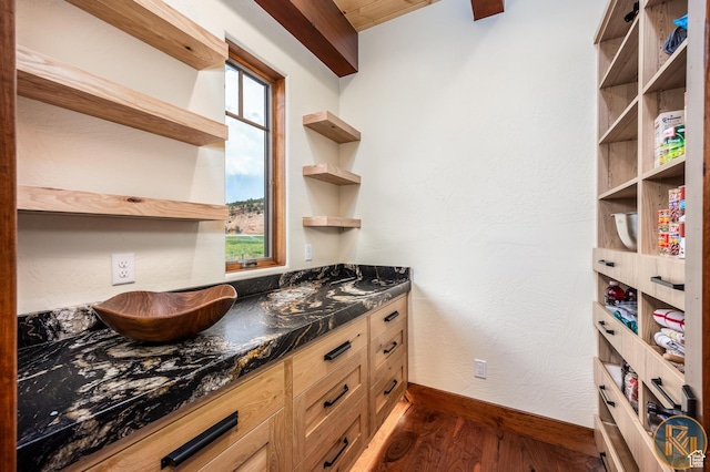5605 N Johnson Canyon Rd, Kanab, UT 84741 - kitchen with open shelves, dark wood-style floors, dark countertops, and baseboards