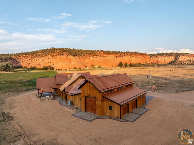 5605 N Johnson Canyon Rd, Kanab, UT 84741 - view of front of house featuring a rural view, a barn, metal roof, and dirt driveway