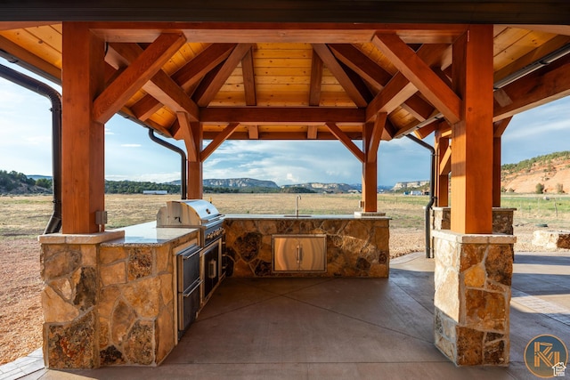 5605 N Johnson Canyon Rd, Kanab, UT 84741 - view of patio with a gazebo, a sink, a mountain view, and a view of rural / pastoral area