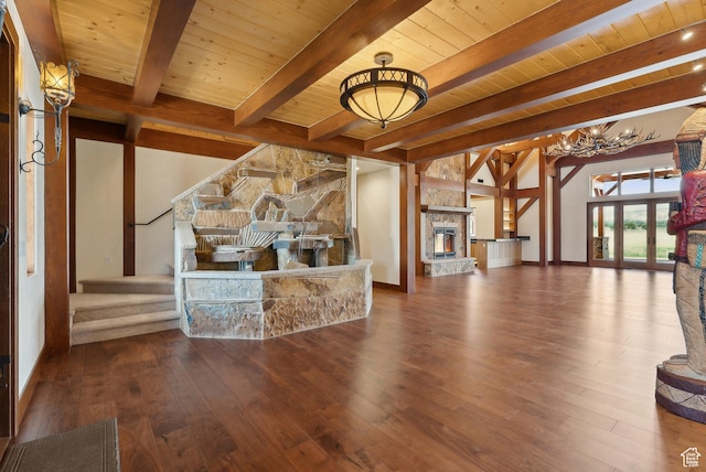5605 N Johnson Canyon Rd, Kanab, UT 84741 - unfurnished living room featuring wooden ceiling with exposed beams, hardwood / wood-style flooring, stairway, a chandelier, and a stone fireplace