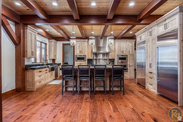 5605 N Johnson Canyon Rd, Kanab, UT 84741 - kitchen with built in refrigerator, wall chimney range hood, wooden ceiling with exposed beams, wood-type flooring, and recessed lighting