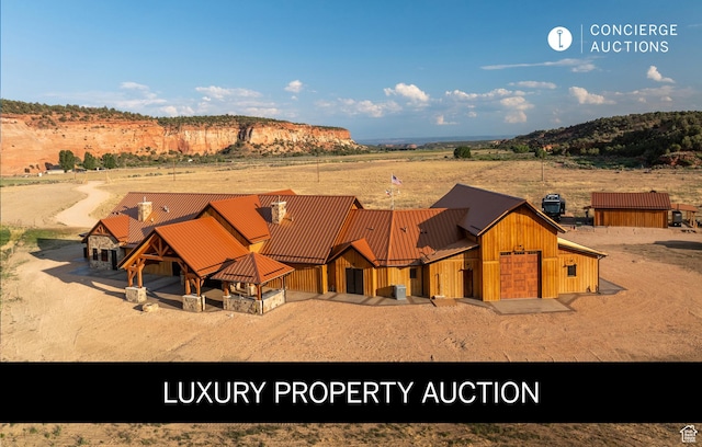 5605 N Johnson Canyon Rd, Kanab, UT 84741 - view of front of property with metal roof, a standing seam roof, a view of countryside, and a detached garage