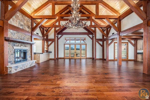 5605 N Johnson Canyon Rd, Kanab, UT 84741 - unfurnished living room featuring a chandelier, high vaulted ceiling, wood-type flooring, a fireplace, and baseboards