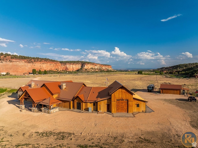 5605 N Johnson Canyon Rd, Kanab, UT 84741 - view of front of home with metal roof, a view of rural / pastoral area, and a standing seam roof