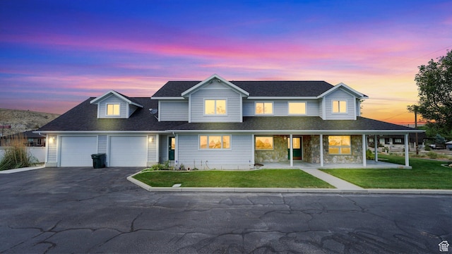 view of front of property featuring a garage and a yard