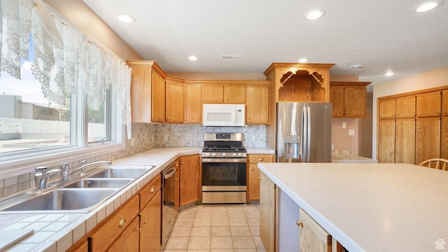 401 N Fairgrounds Rd, Price, UT 84501 - kitchen with sink, decorative backsplash, light tile patterned flooring, and appliances with stainless steel finishes