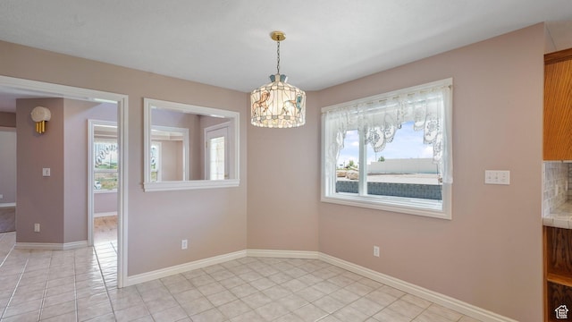401 N Fairgrounds Rd, Price, UT 84501 - unfurnished room featuring an inviting chandelier and light tile patterned floors